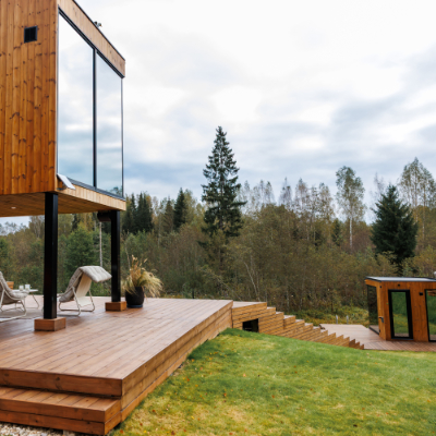 Detached deck in a backyard with seating and fire pit