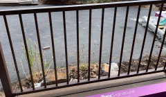 Trex® railing box beside black metal railings on wood deck overlooking frozen lake