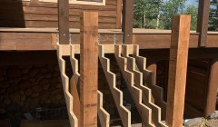 Framework for wooden staircase to wood deck with adjacent support beans