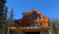 Large wooden deck above ground-level garage of custom cherry wood home