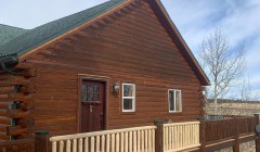 Walnut log cabin and adjacent white oak deck with pine wood railings