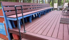 Large redwood deck with wooden benches spanning full lefthand edge