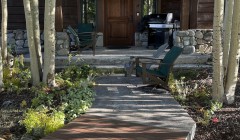 Wood and concrete walkway to walnut wood cabin