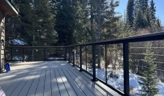 Composite wood deck with cable railings at dusk