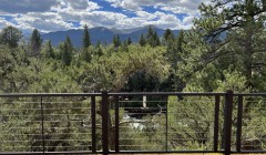 Mountainscape and forest view from upper-level composite wood deck