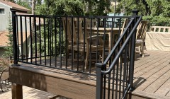 Walnut staircase to wooden porch with patio table and four outdoor chairs