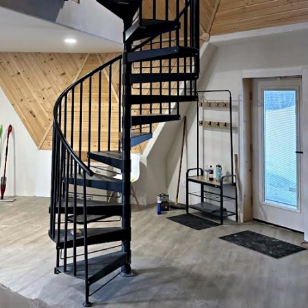 Black metal staircase in wood cabin living room />
        </div>
    </div>
</div>






<h3>Durability and Maintenance</h3>
<p>Galvanized or powder-coated steel components are highly resistant to snow, rain, and UV damage. These low-maintenance materials are perfect for Colorado’s harsh winters and strong sun, ensuring your staircase remains safe and beautiful for years to come.</p>
<h2>Practical Considerations and Limitations</h2>

<p>While spiral stairs are versatile and stylish, they do come with considerations. They’re typically steeper than traditional stairs and may not be ideal as a home’s primary staircase. Choosing the appropriate diameter is key to comfort and accessibility. Wider stairs are easier to use but take up more space. Fully customized spiral stairs can also be more costly upfront, but their design benefits and small footprint often outweigh the initial investment.</p>

<div class=